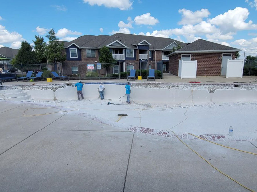 What sets Barton Pool Company apart - construction crew preparing concrete driveway site at residential home with professional equipment