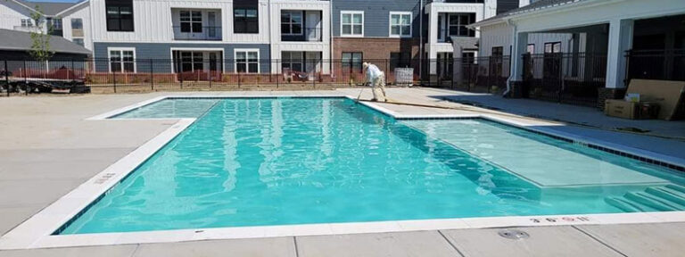 Request a pool consultation - commercial rectangular inground pool with turquoise water and modern concrete deck by Barton Pool Company