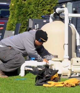 Barton Pool Company technician servicing pool filter and pump equipment